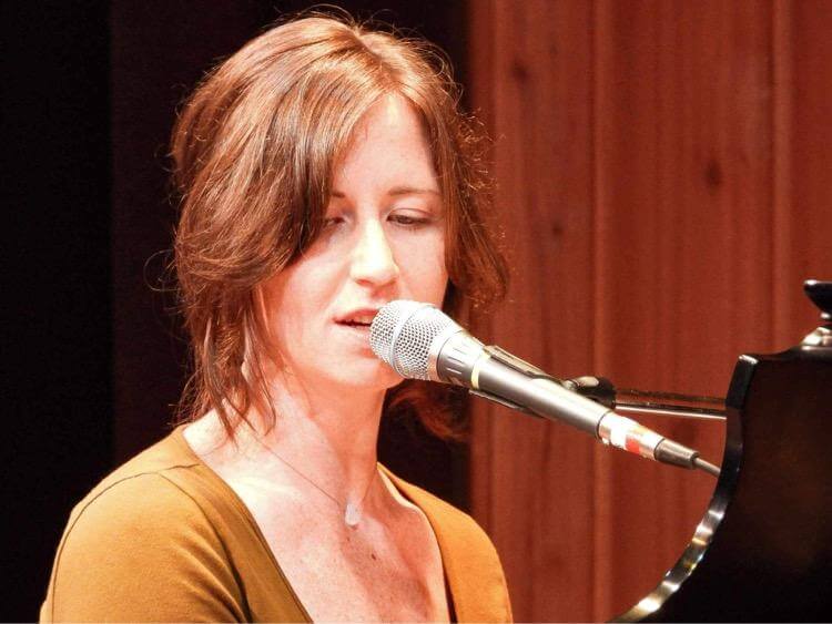 Joni Clare performing at piano